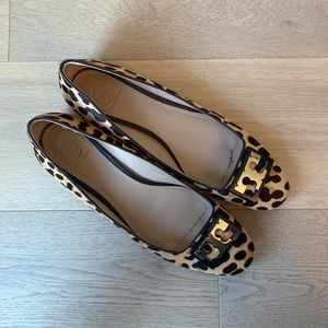 Tory Burch leopard print loafers with gold toe detail.